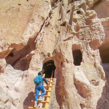 Exploring a cavate, or carved room, at Bandelier National Monument